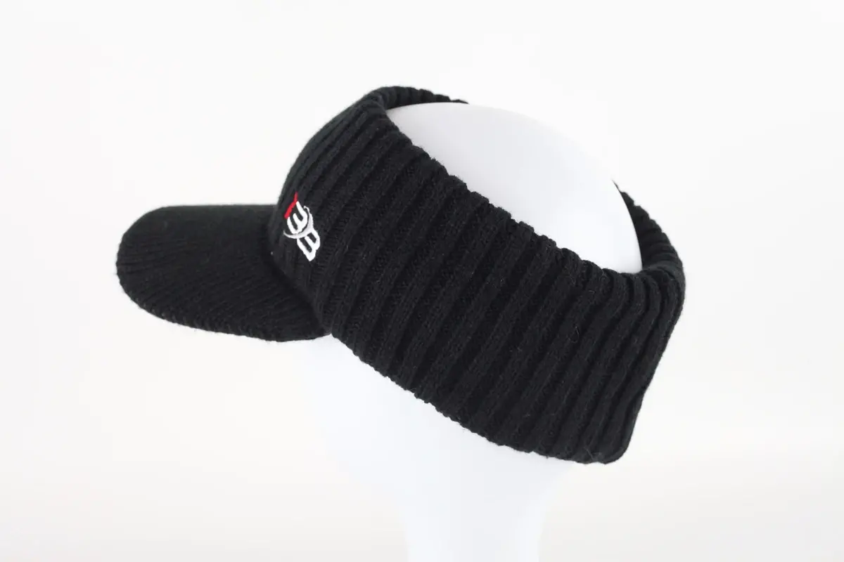 Black rib-knit beanie shown from the side on a white display form