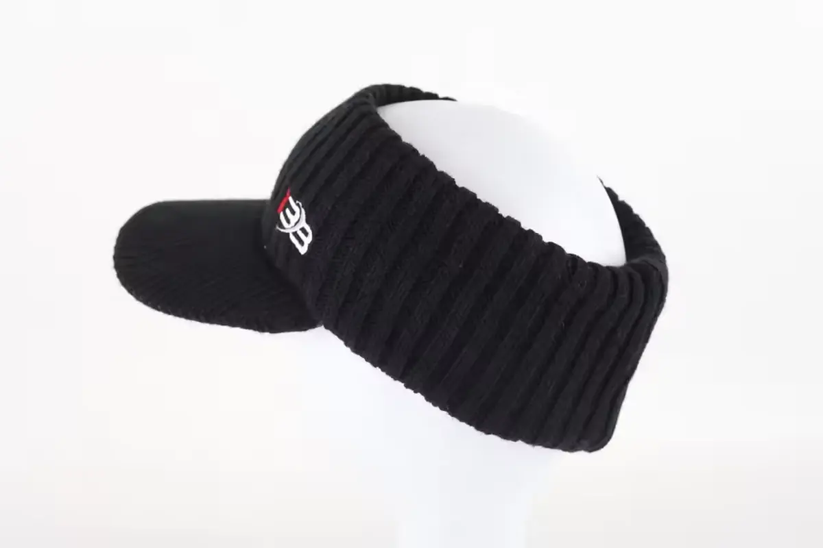 Black knit beanie with a short folded cuff, shown on a white display form