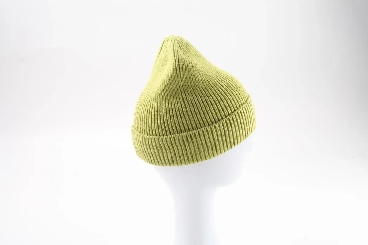 Light green rib-knit beanie with a tall crown on a white display form