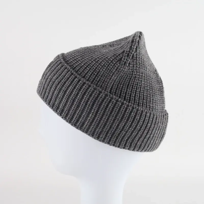 Gray rib-knit beanie shown in side profile on a display form