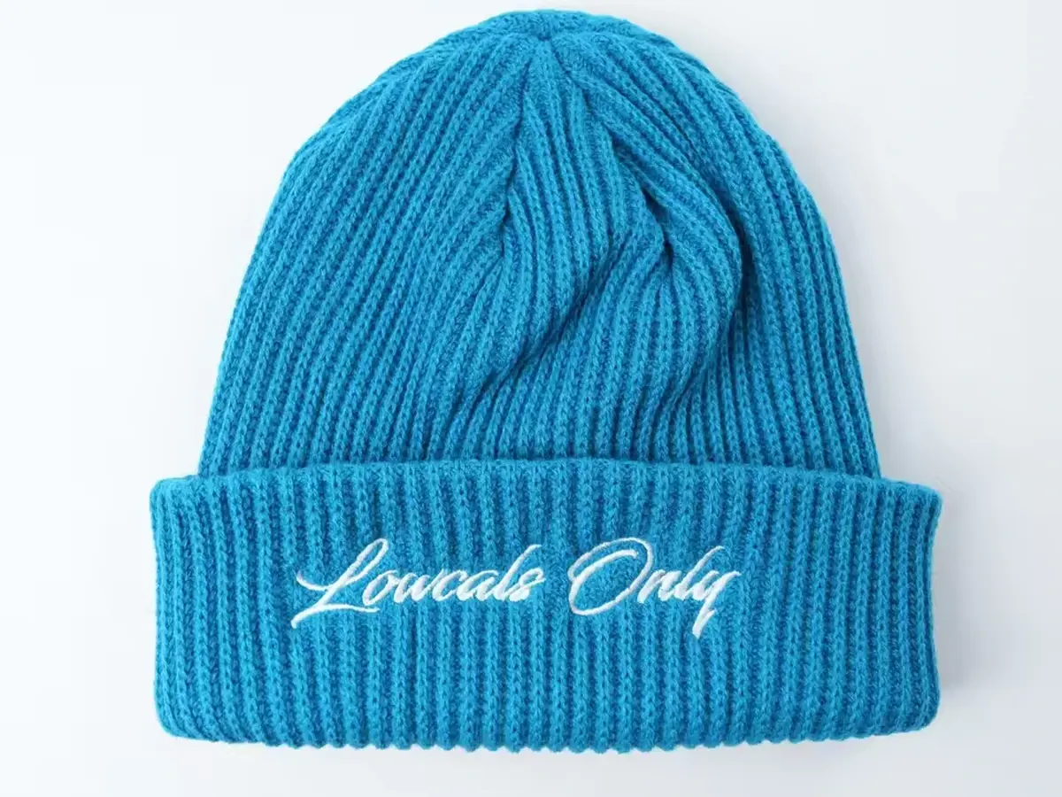 Blue rib-knit beanie with white cuff embroidery