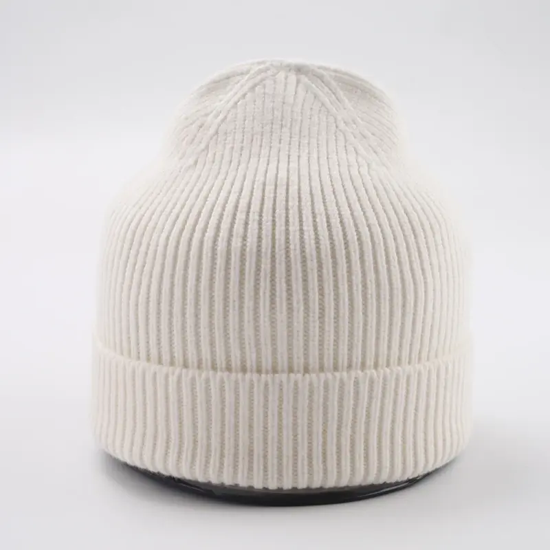 Ivory rib-knit beanie with a folded cuff on a display form