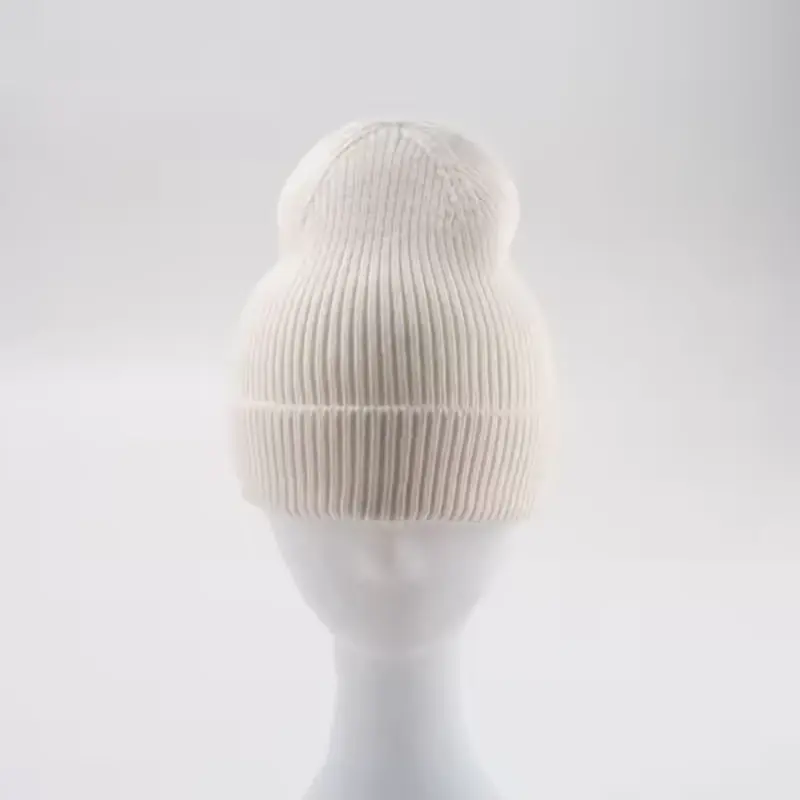 White rib-knit beanie with a folded cuff on a display form