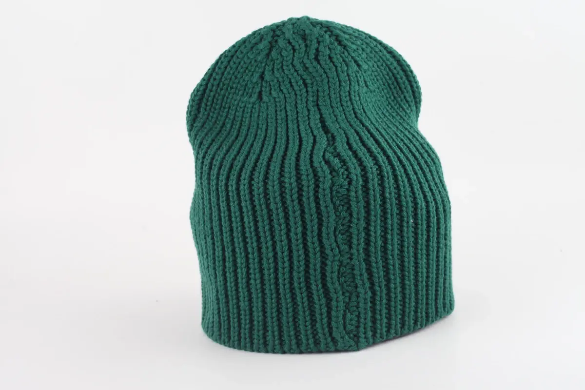 Dark green rib-knit beanie with a tall crown and folded cuff
