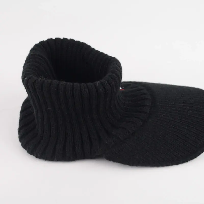Black rib-knit beanie shown in profile on a white background
