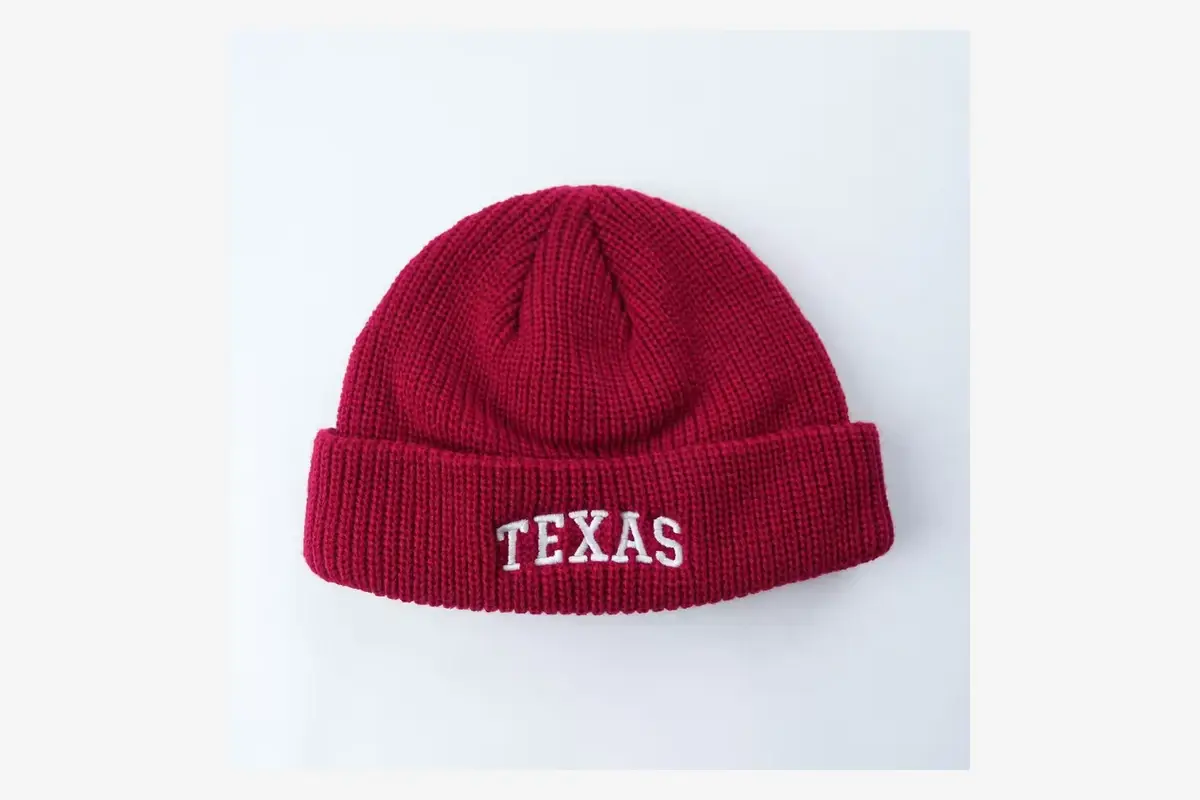 White TEXAS embroidery centered on a red beanie cuff.