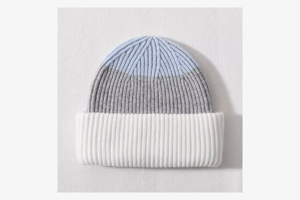 Gray and white rib-knit beanie laid flat for sample review.