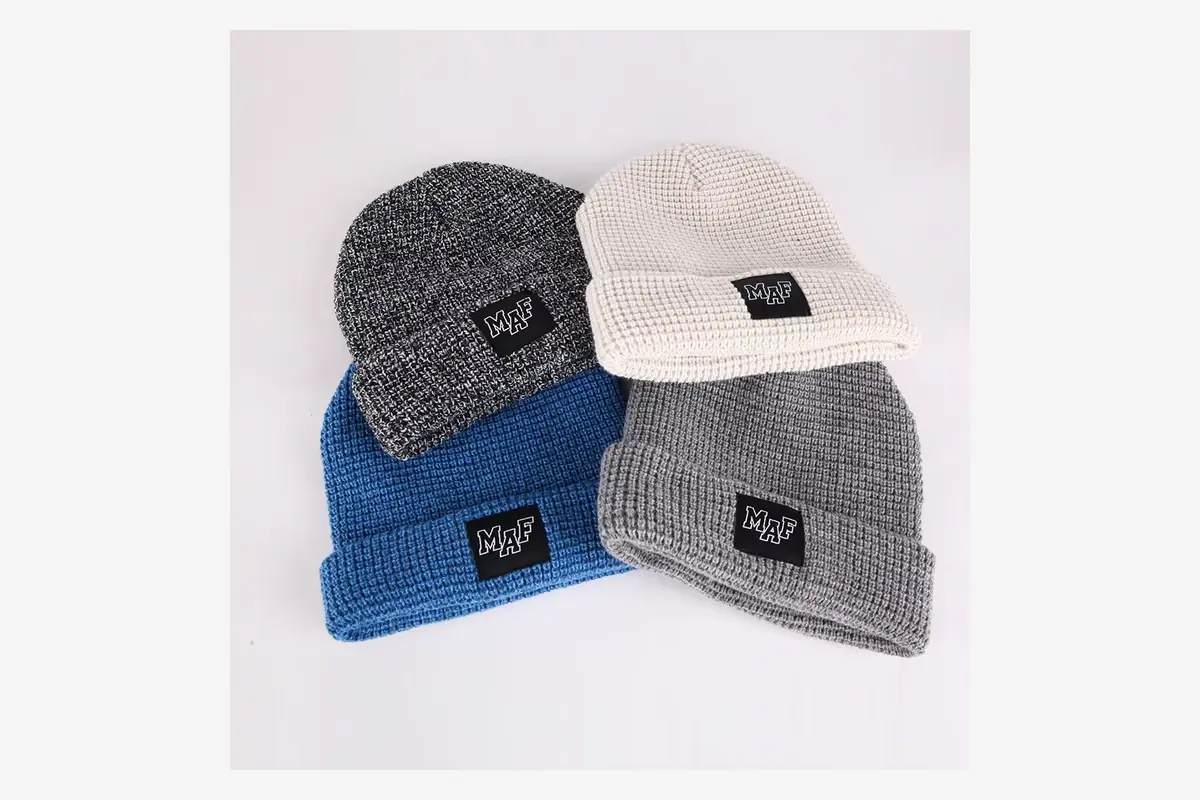 Four waffle-knit beanie variations with sewn front labels.