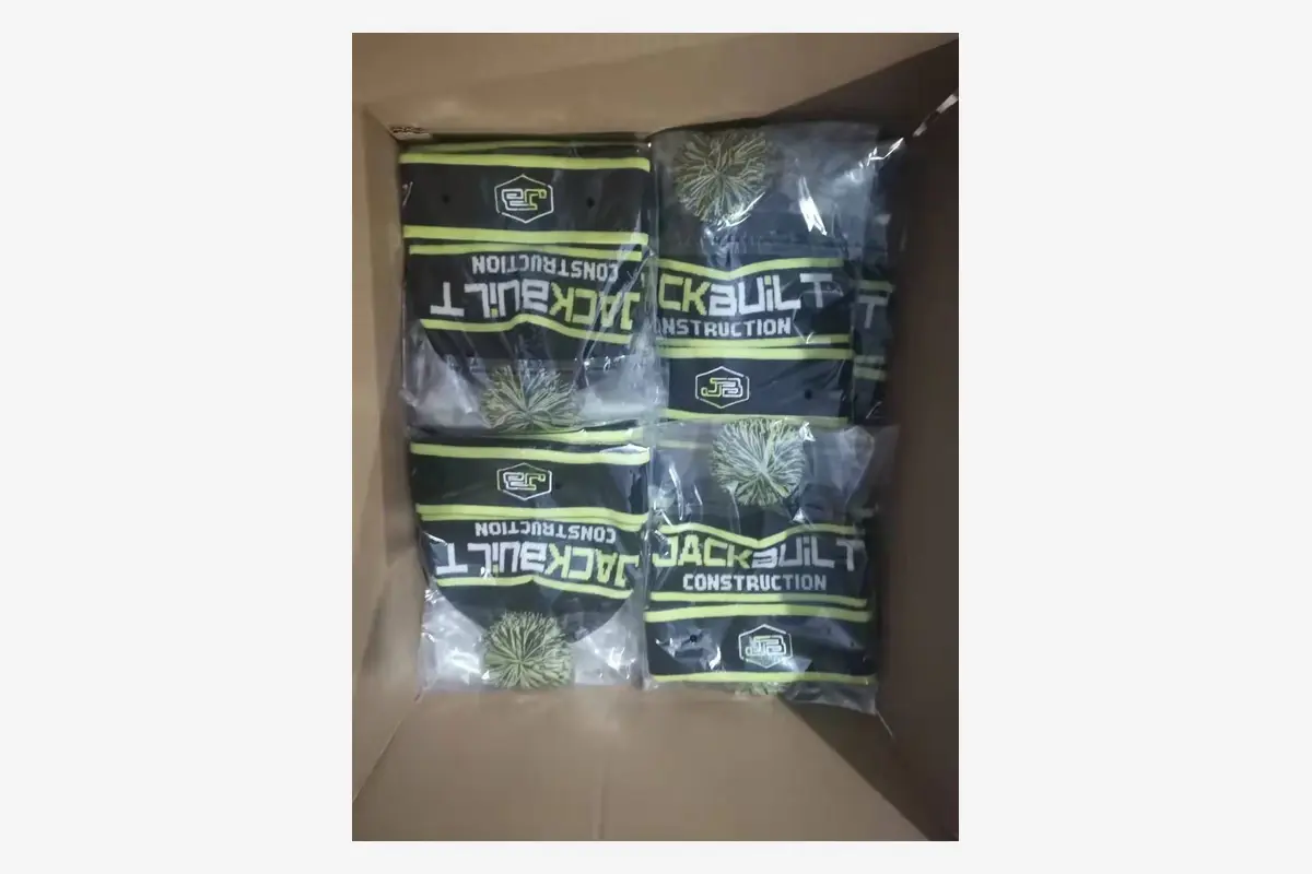 Bagged knit beanies arranged inside a shipping carton.