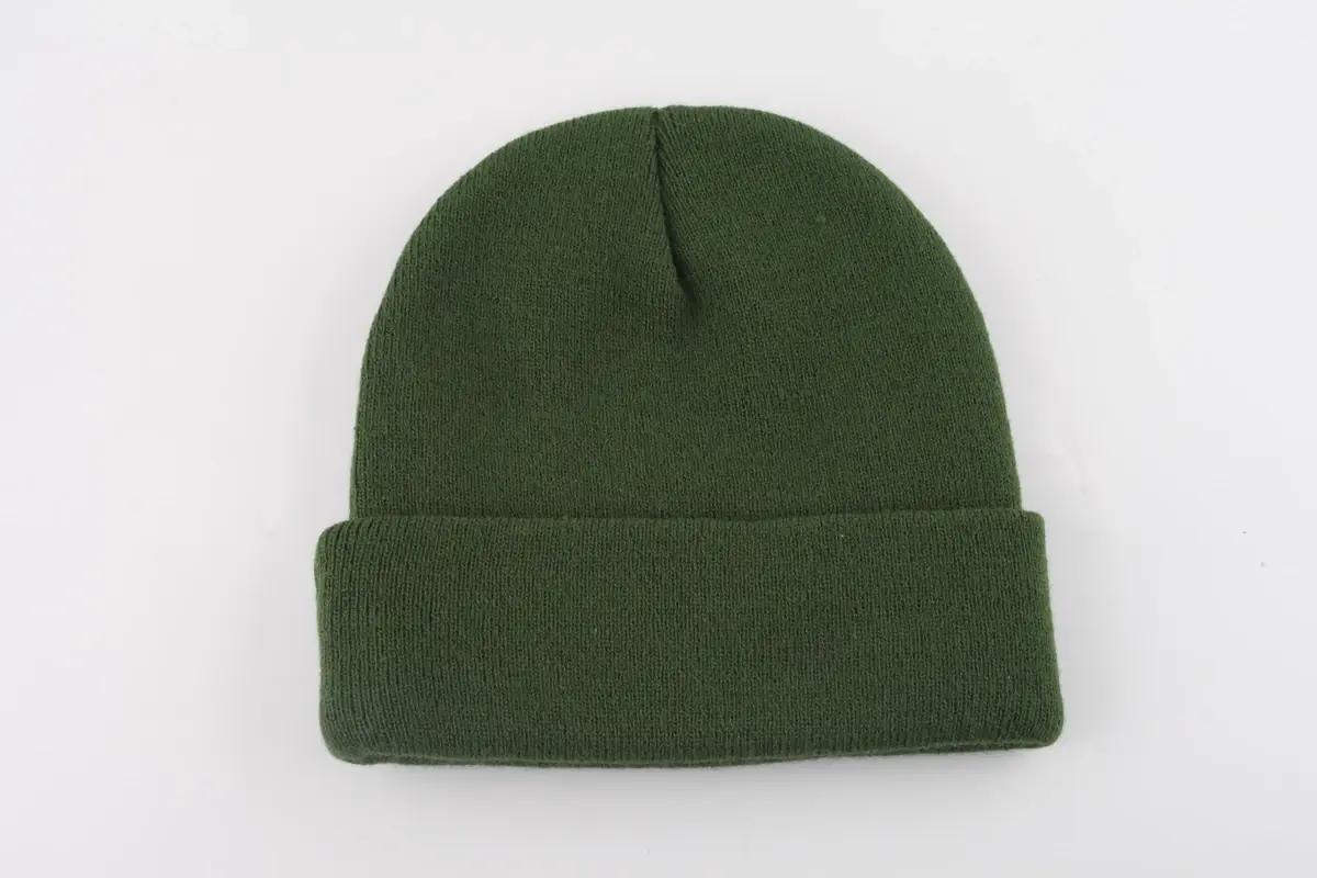 Green rib-knit cuffed beanie on a light background