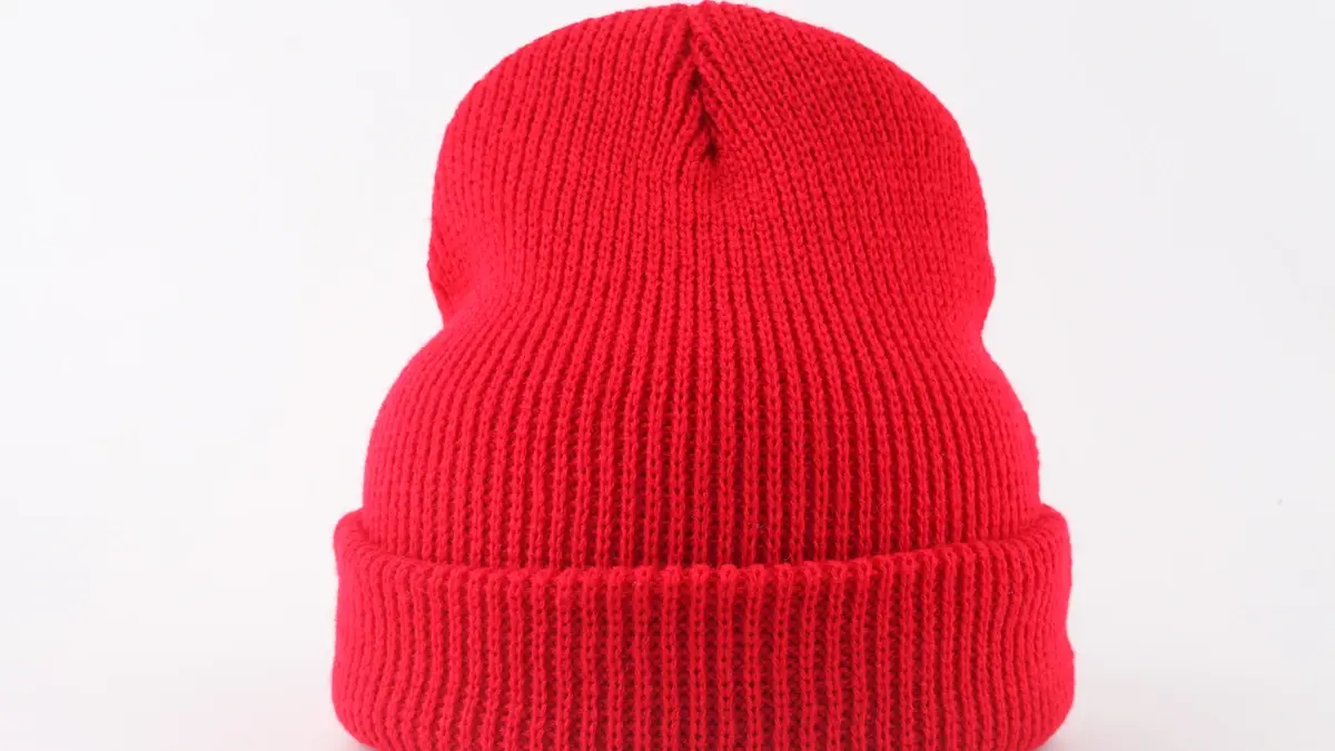 Red rib-knit beanie with a folded cuff.