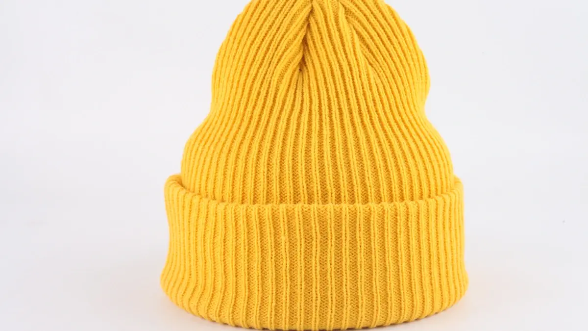 Yellow rib-knit beanie with a folded cuff.
