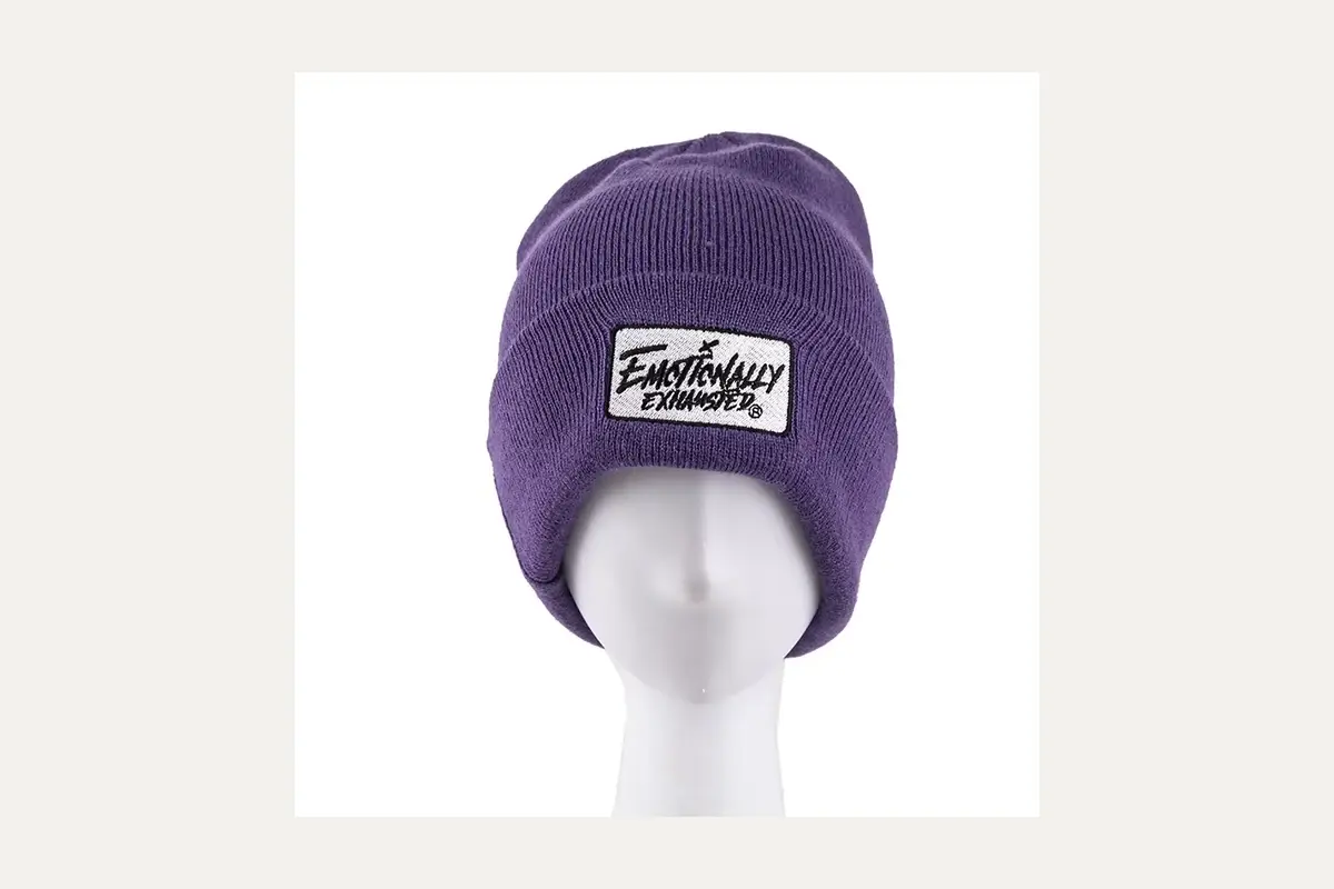 Purple cuffed beanie with a sewn logo patch.