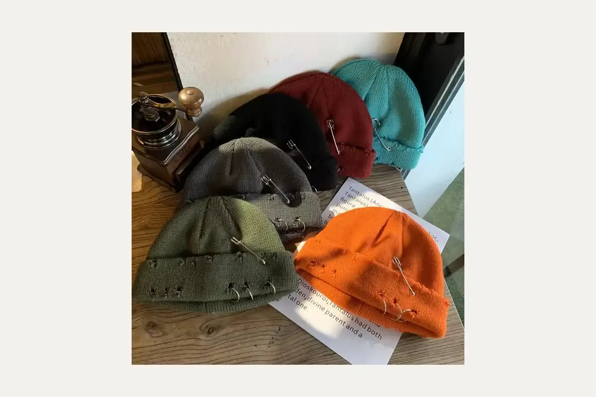 Assorted short knit beanies in different shapes and colors.