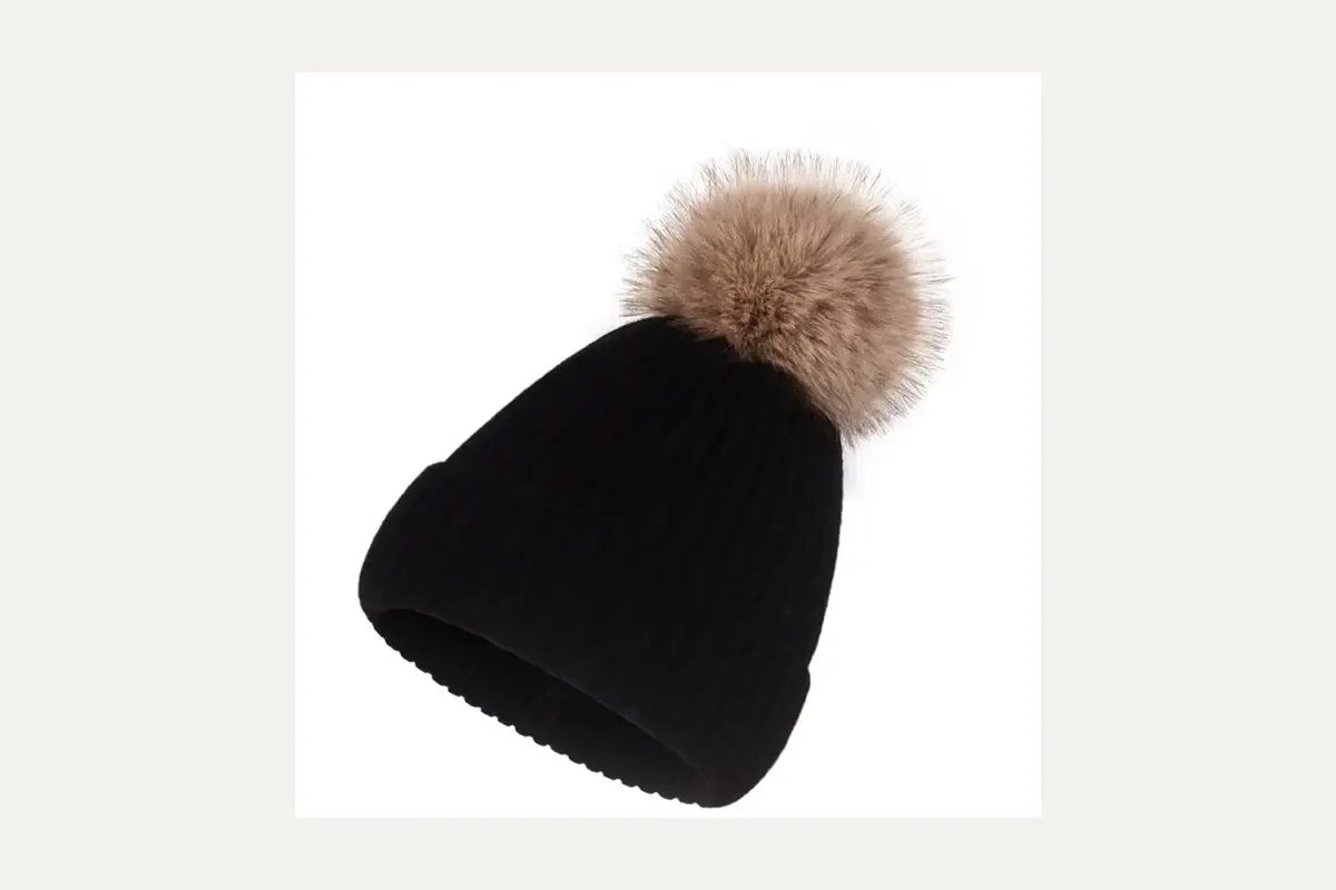 Black knit beanie with a brown faux fur pom pom.