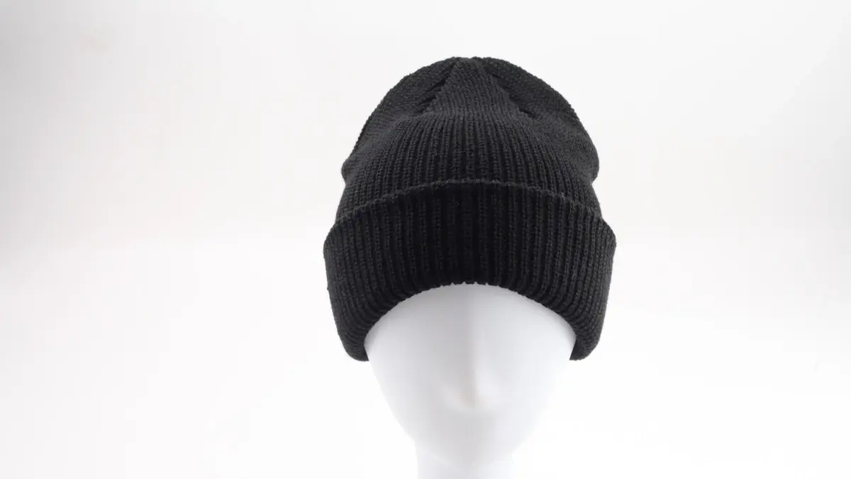 Black rib-knit beanie displayed on a white head form.