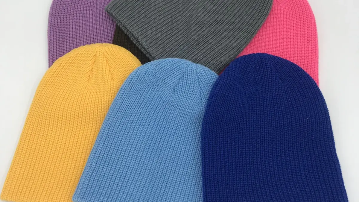Several rib-knit beanies in different colors.