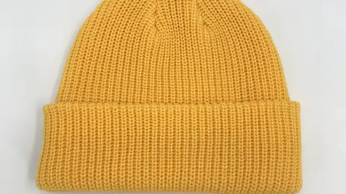 Yellow rib-knit beanie with a folded cuff.