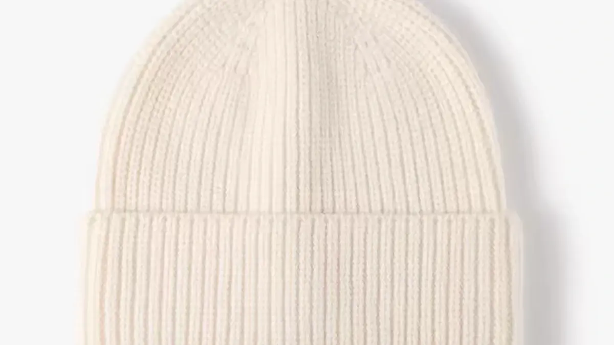 White rib-knit beanie with a folded cuff.