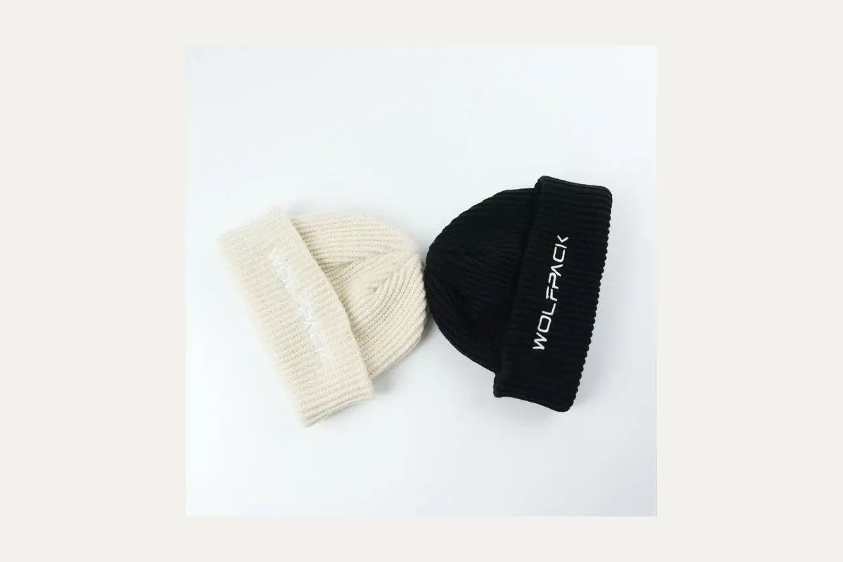 Two finished knit beanies for sample review.