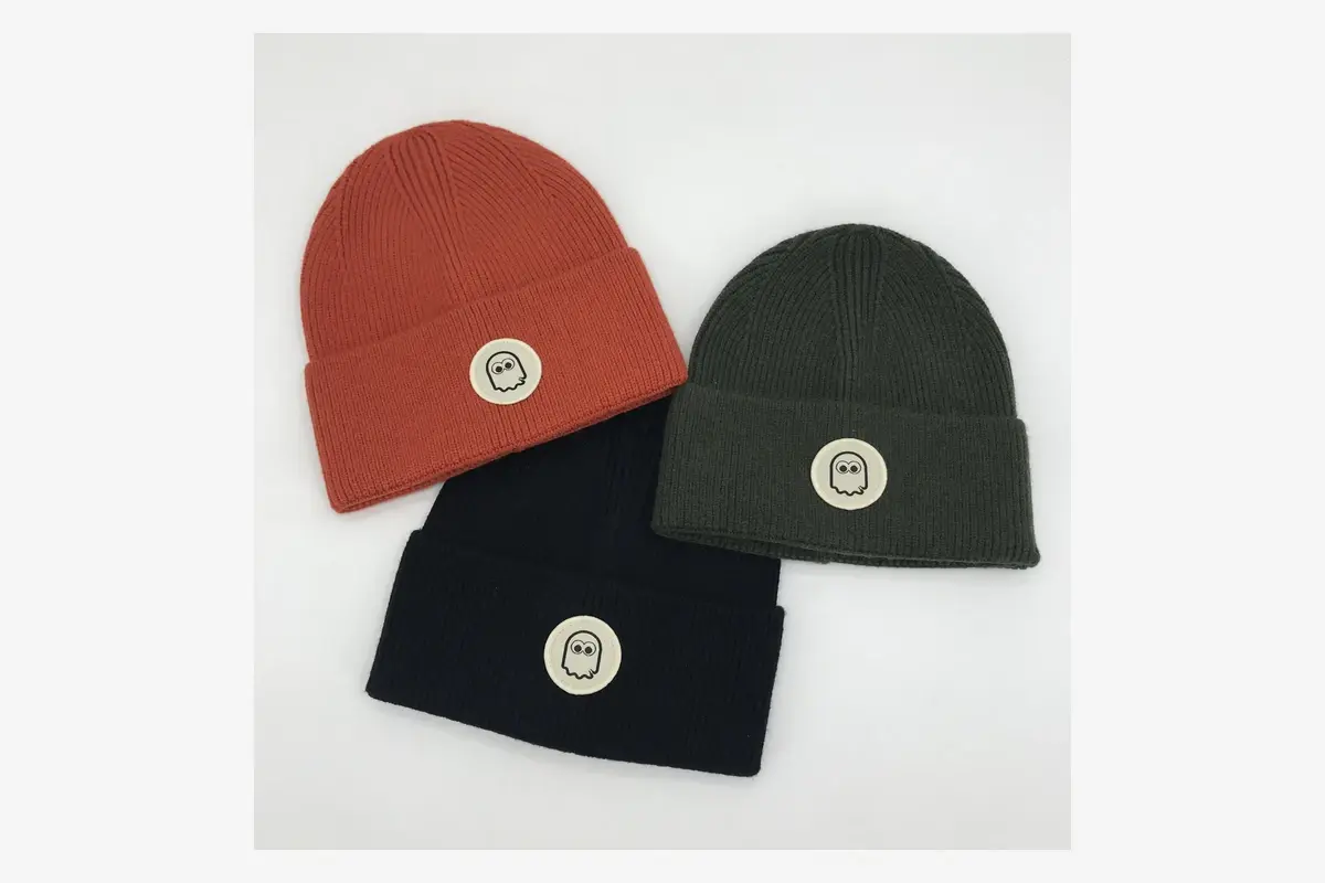 Three cuffed beanies with round front patches.