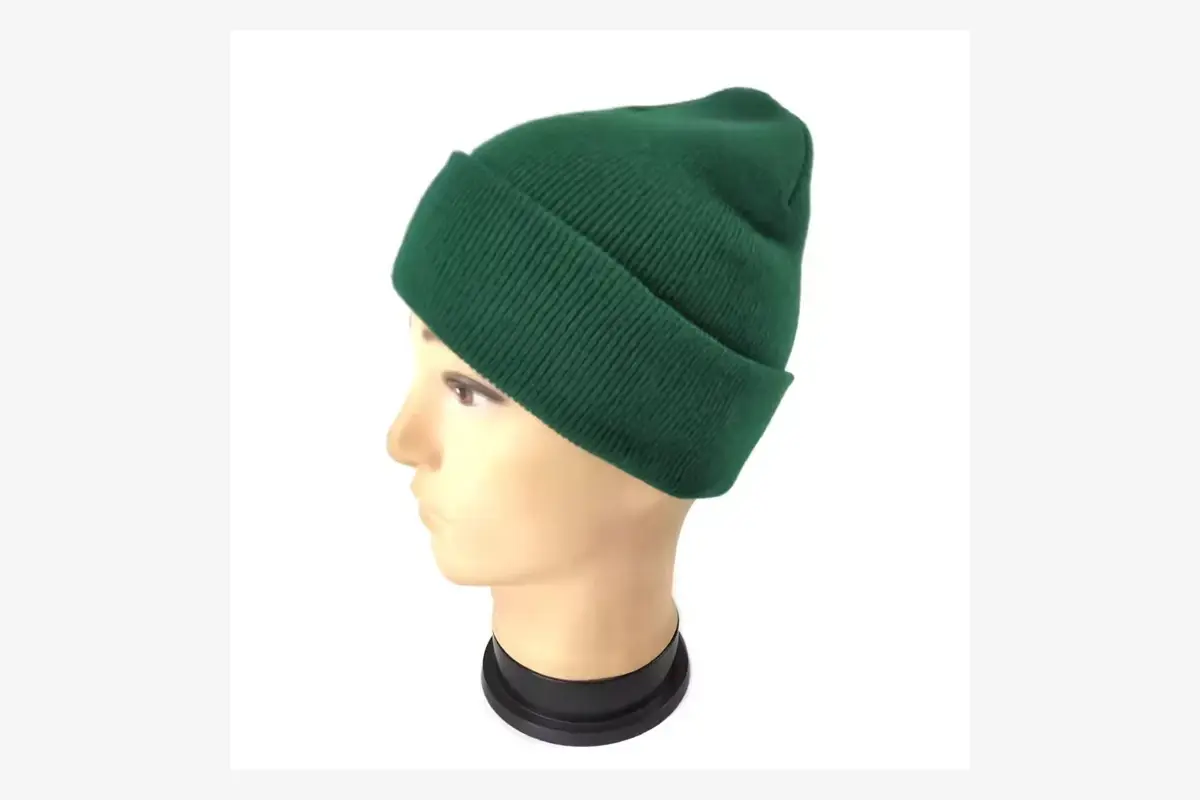 Green cuffed knit beanie fitted on a head form.