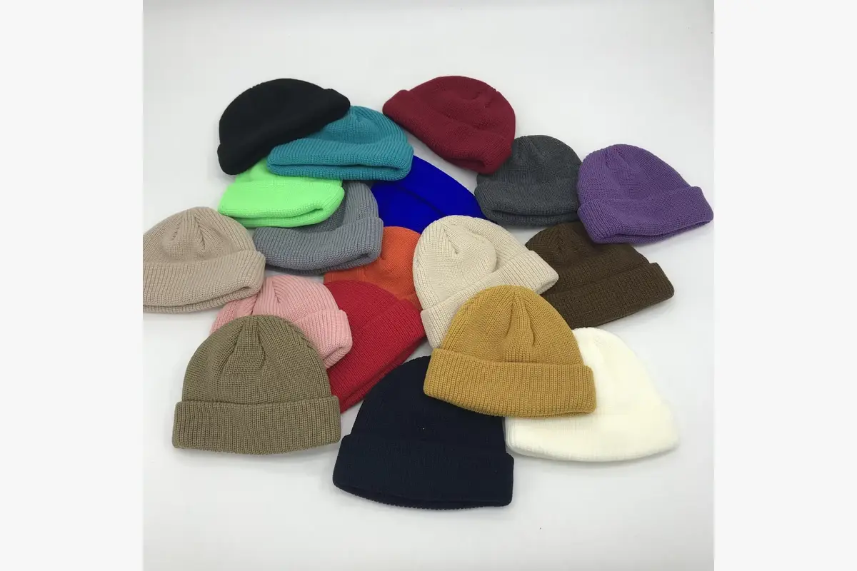 Assorted plain cuffed beanies in different colors and knit shapes