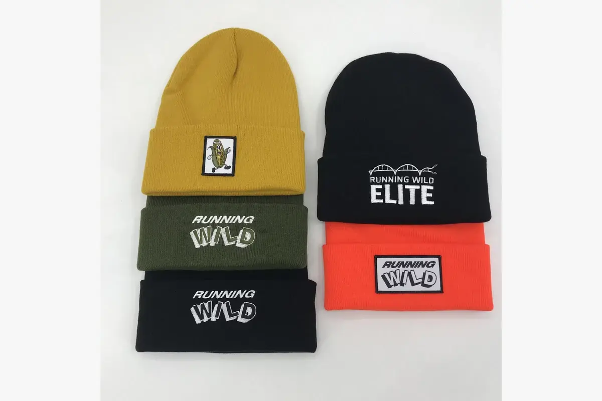 Four cuffed beanies with different front logo treatments and placements