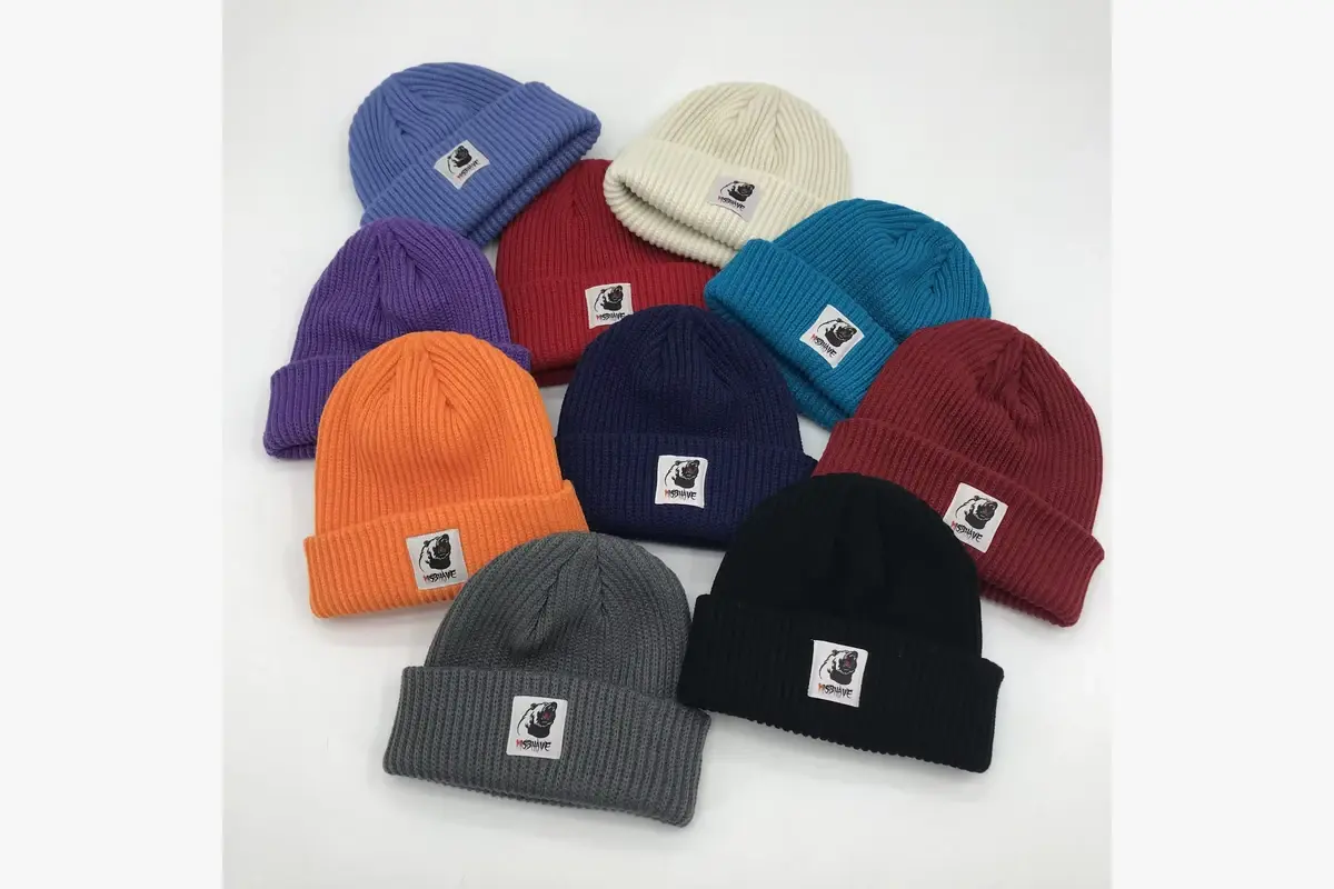Assorted finished cuffed beanies with front labels