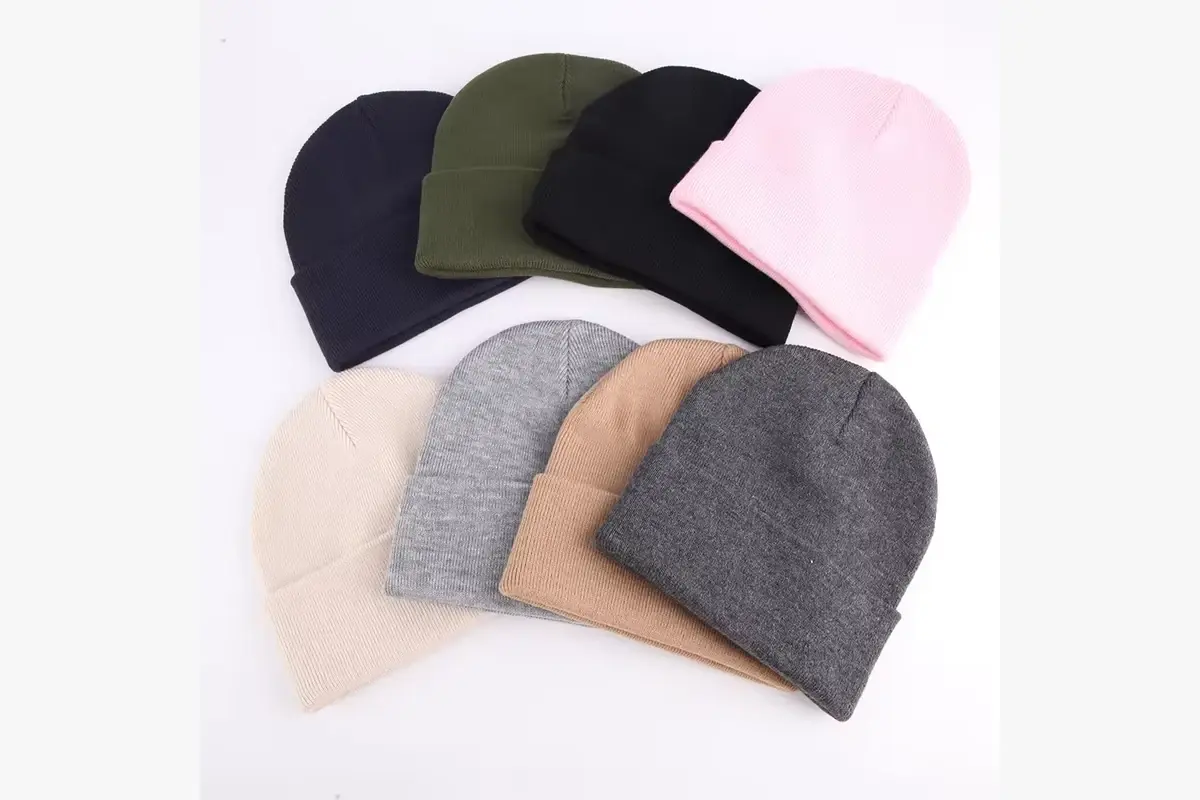 Cuffless knit beanies in several colors shown in one assortment