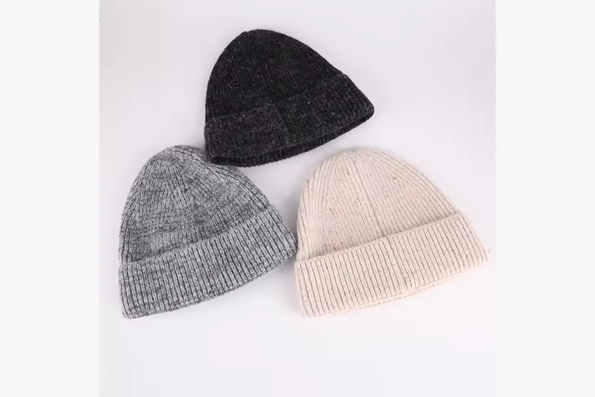 Three plain rib-knit beanies in charcoal gray, light gray and cream