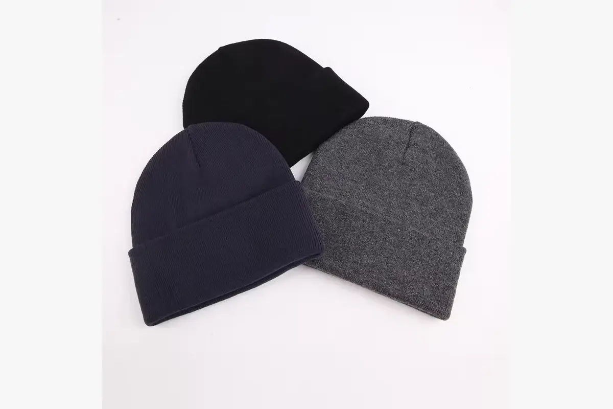 Three plain beanies in black, navy and gray arranged side by side