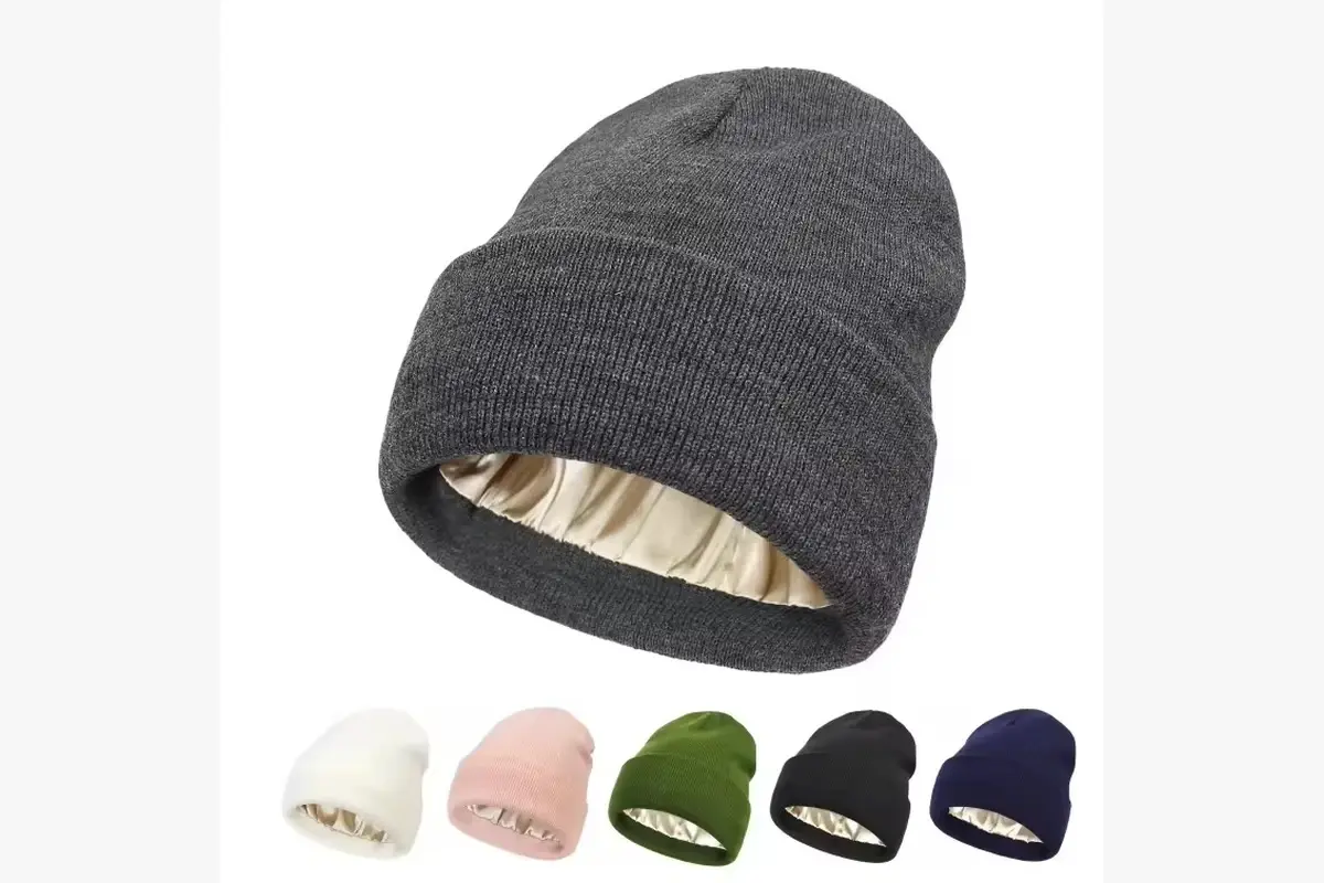 Gray knit beanie angled to show its light-colored inner lining