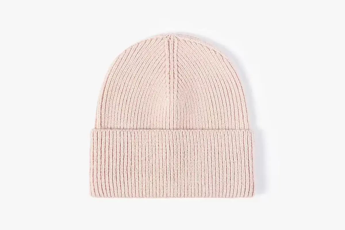 Pale pink rib-knit beanie with a deep turned-up cuff