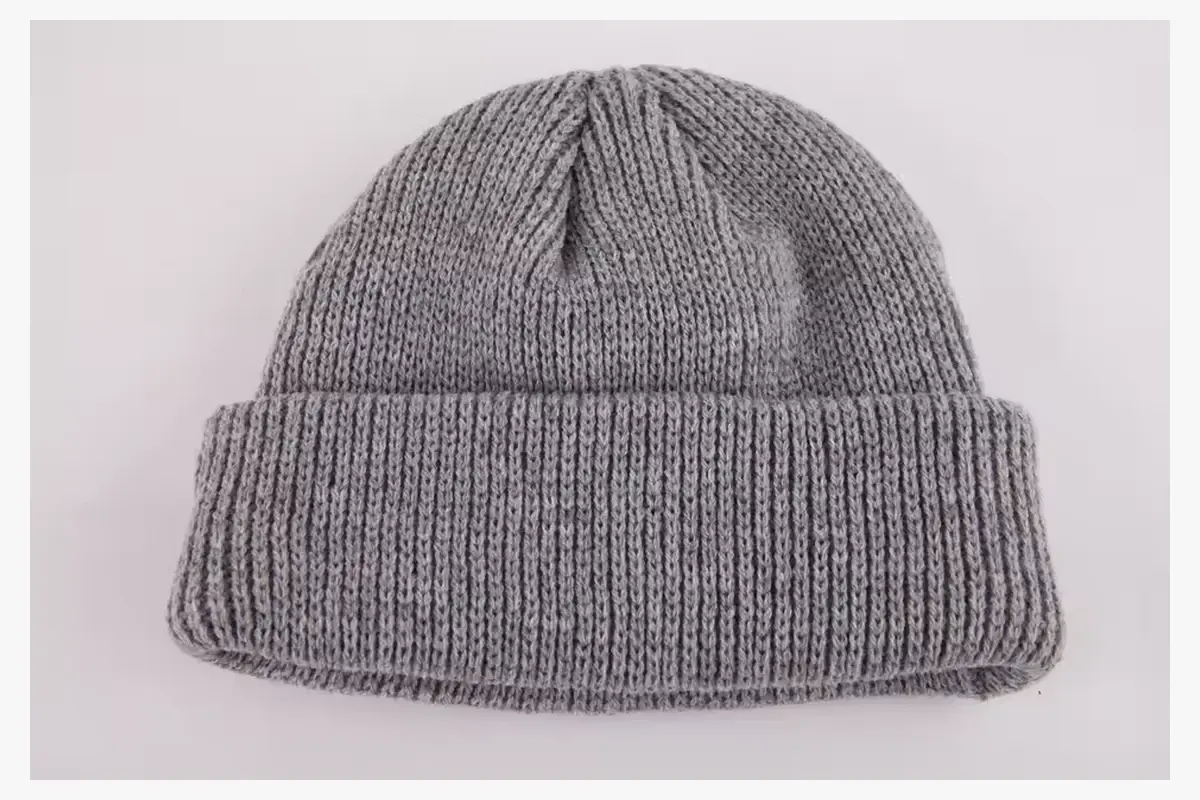 Plain gray rib-knit beanie laid flat with its cuff folded