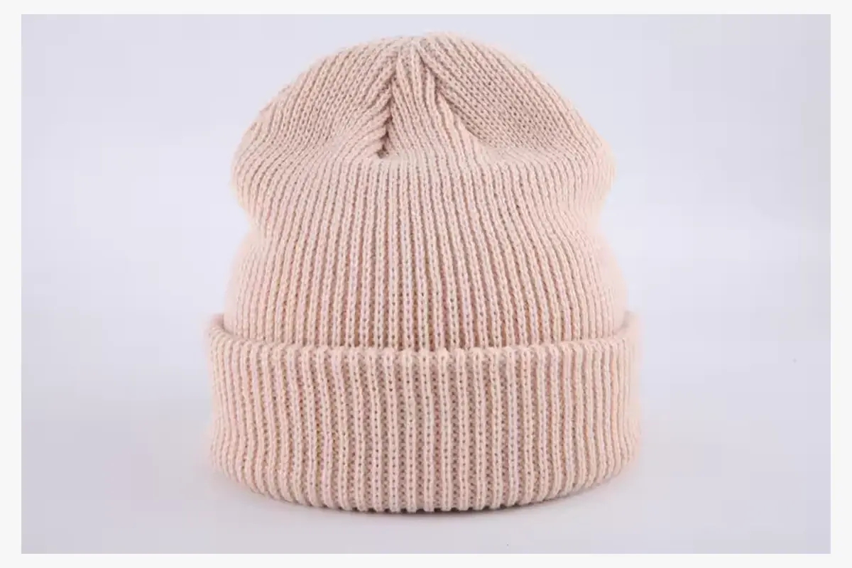 Pale peach rib-knit beanie with a tall folded cuff