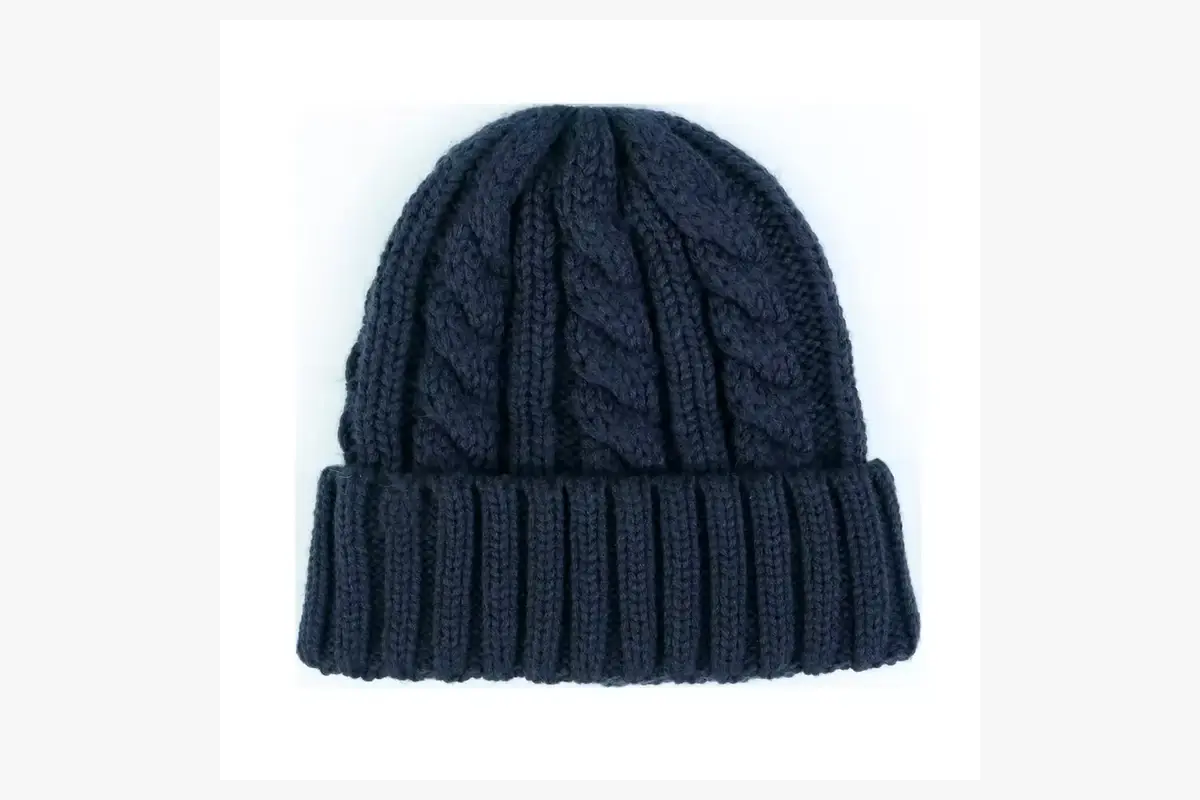 Navy cable-knit beanie with a folded ribbed cuff