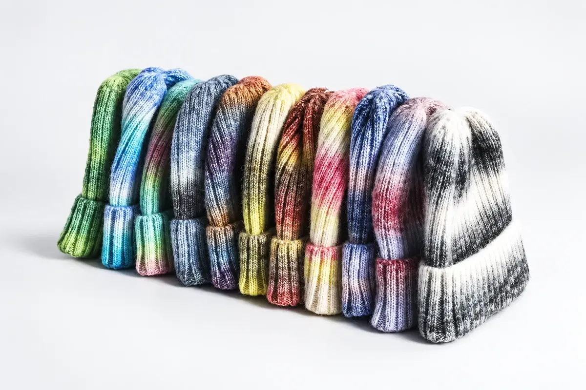 Colorful cuffed beanies arranged to show varied ribbed knit textures