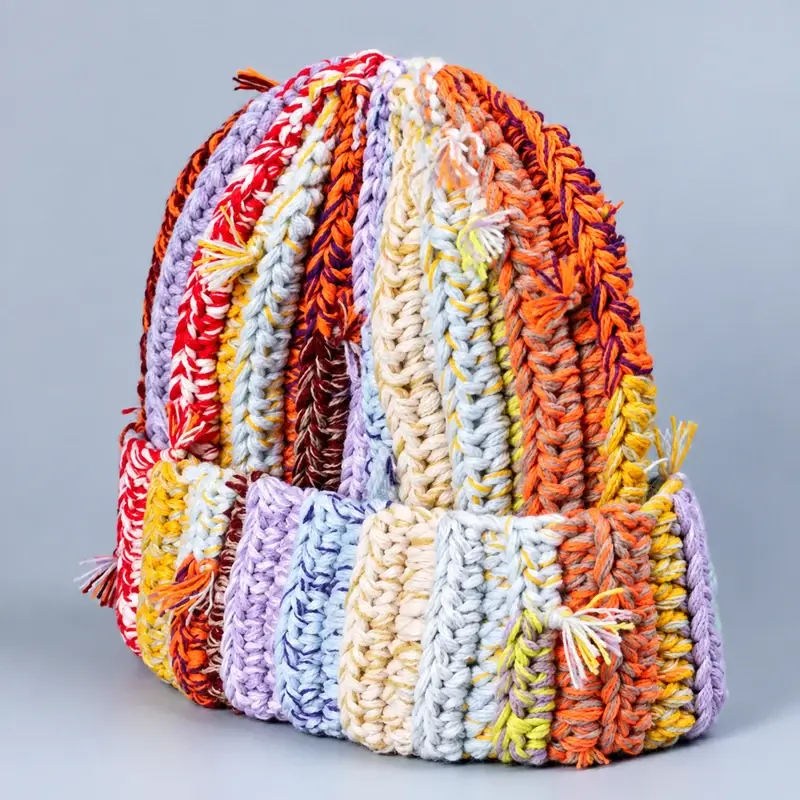 Assorted colorful cuffed beanies showing oversized chunky cable knit stitches