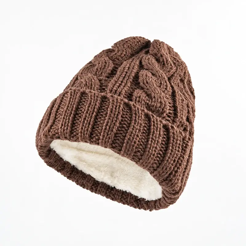 Brown cable-knit cuffed beanie turned open to show plush fleece lining