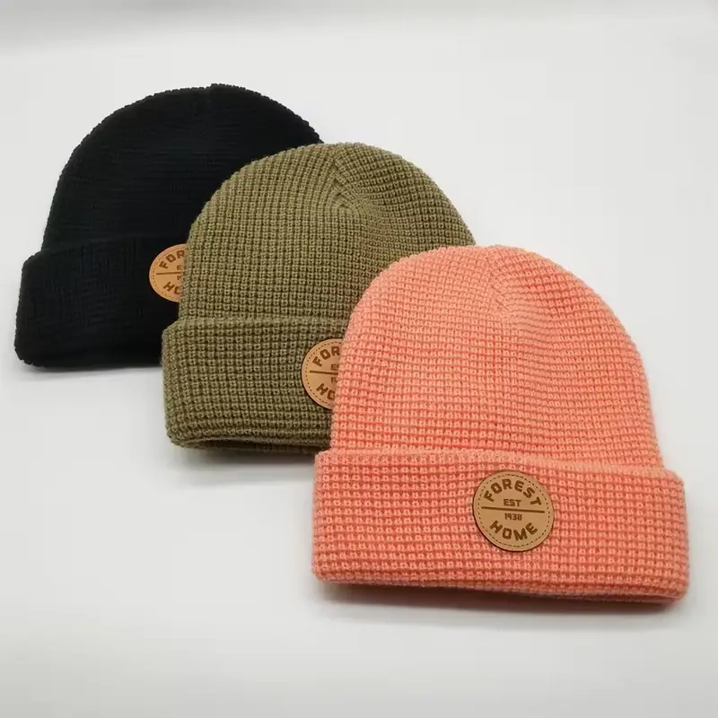 Three black, olive and coral waffle-knit fisherman beanies
