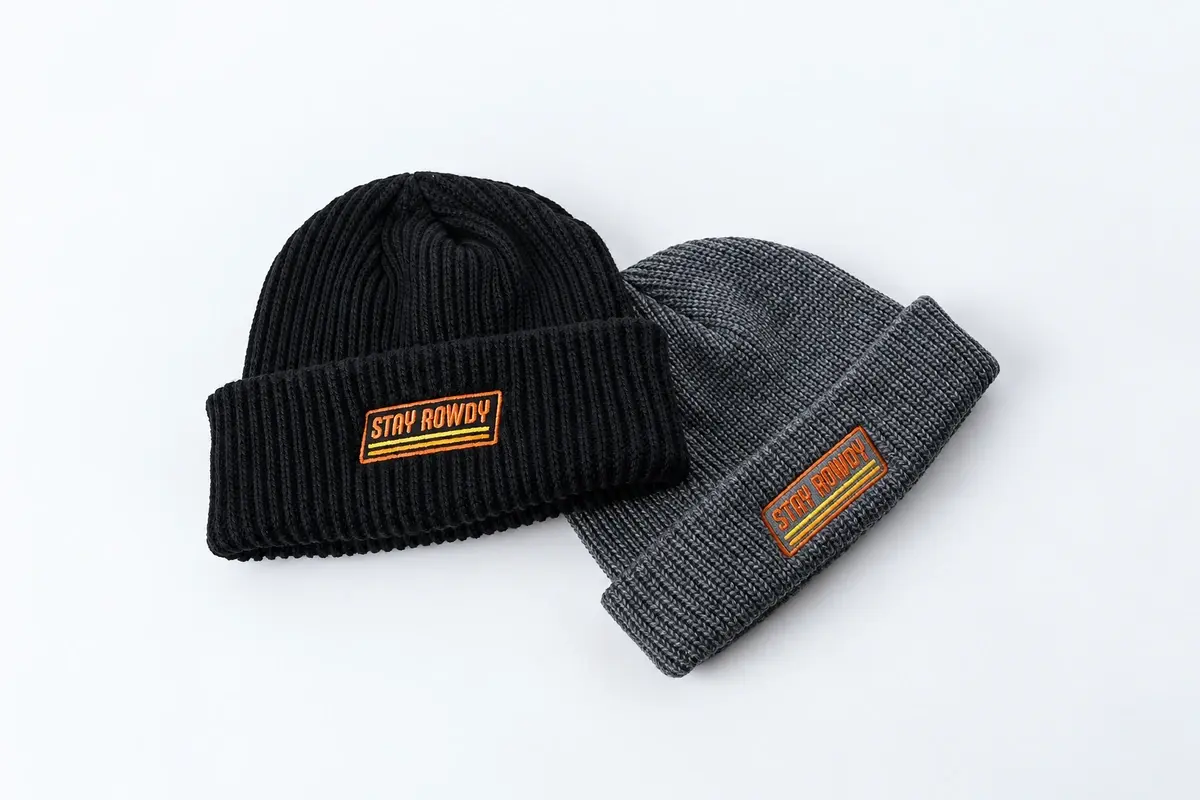 Navy and gray short fisherman beanies with embroidered and sewn cuff patches