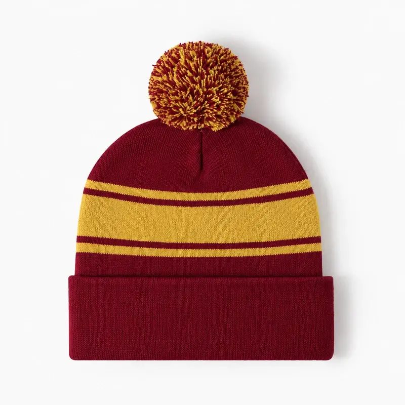 Burgundy and gold yarn pom pom beanie with a folded cuff