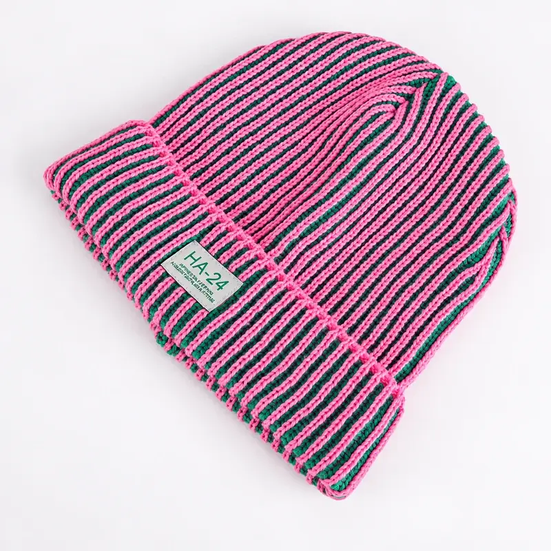 Folded pink and green striped knit beanie with woven label