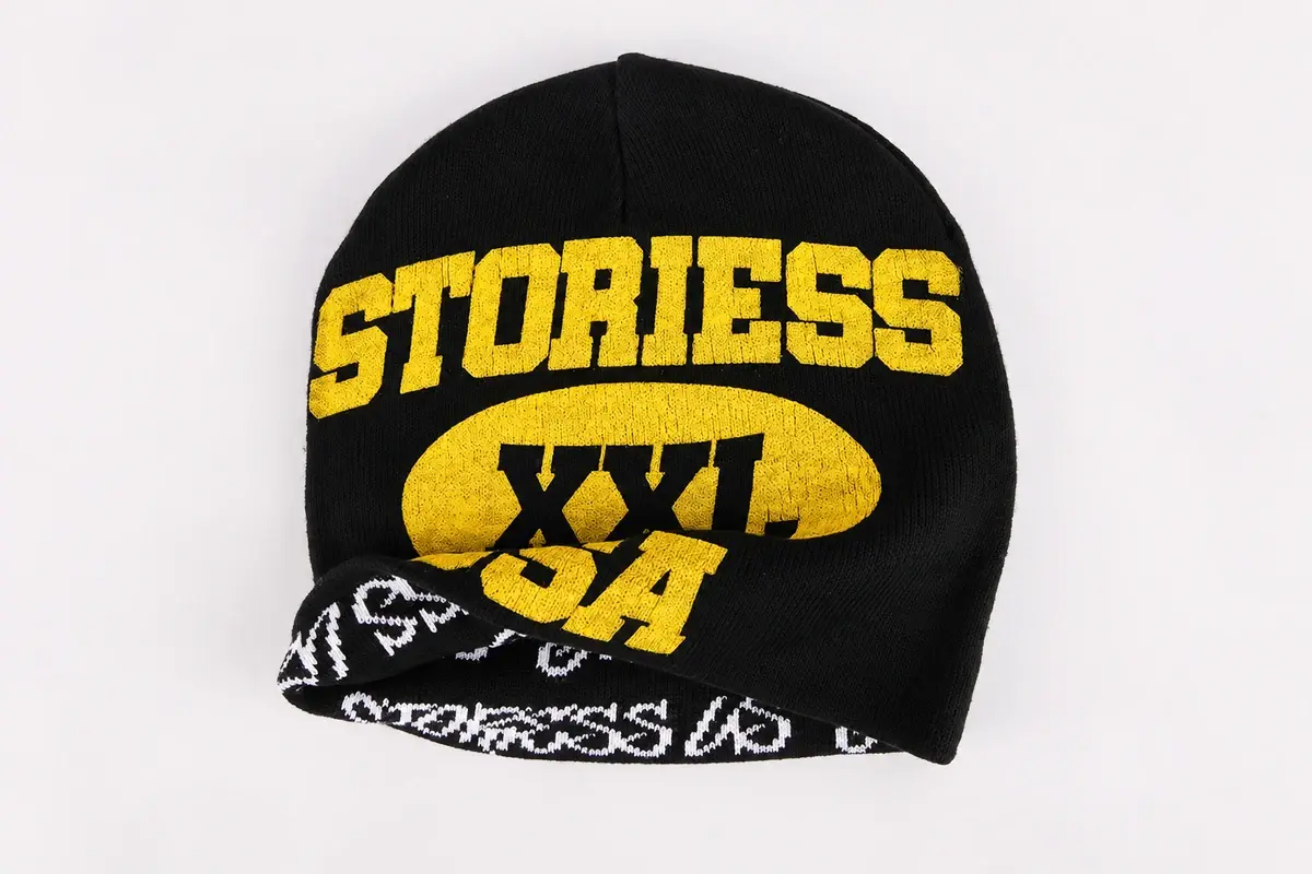 Front-facing black rib-knit beanie with gold embroidered logo