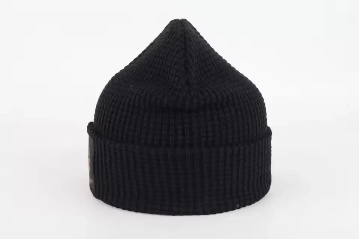 Black rib-knit cuffed beanie on a white background
