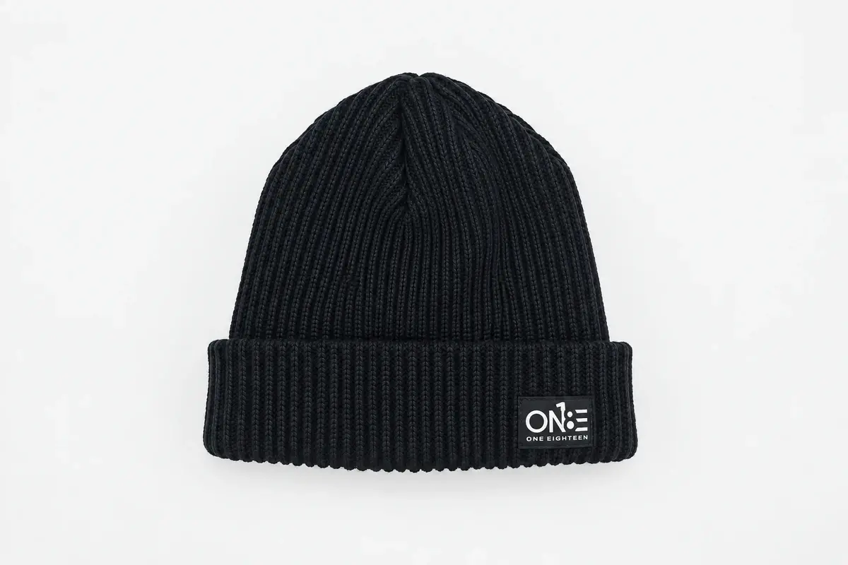 Dark navy rib-knit cuffed beanie with small ONE patch