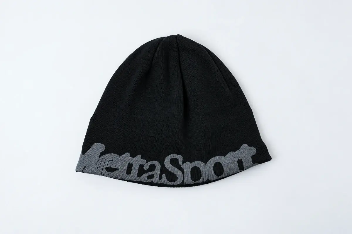 Black cuffless knit beanie with a small logo and straight lower edge