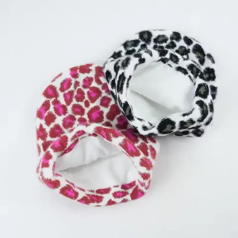 Two patterned knit beanies opened to show white brushed inner lining