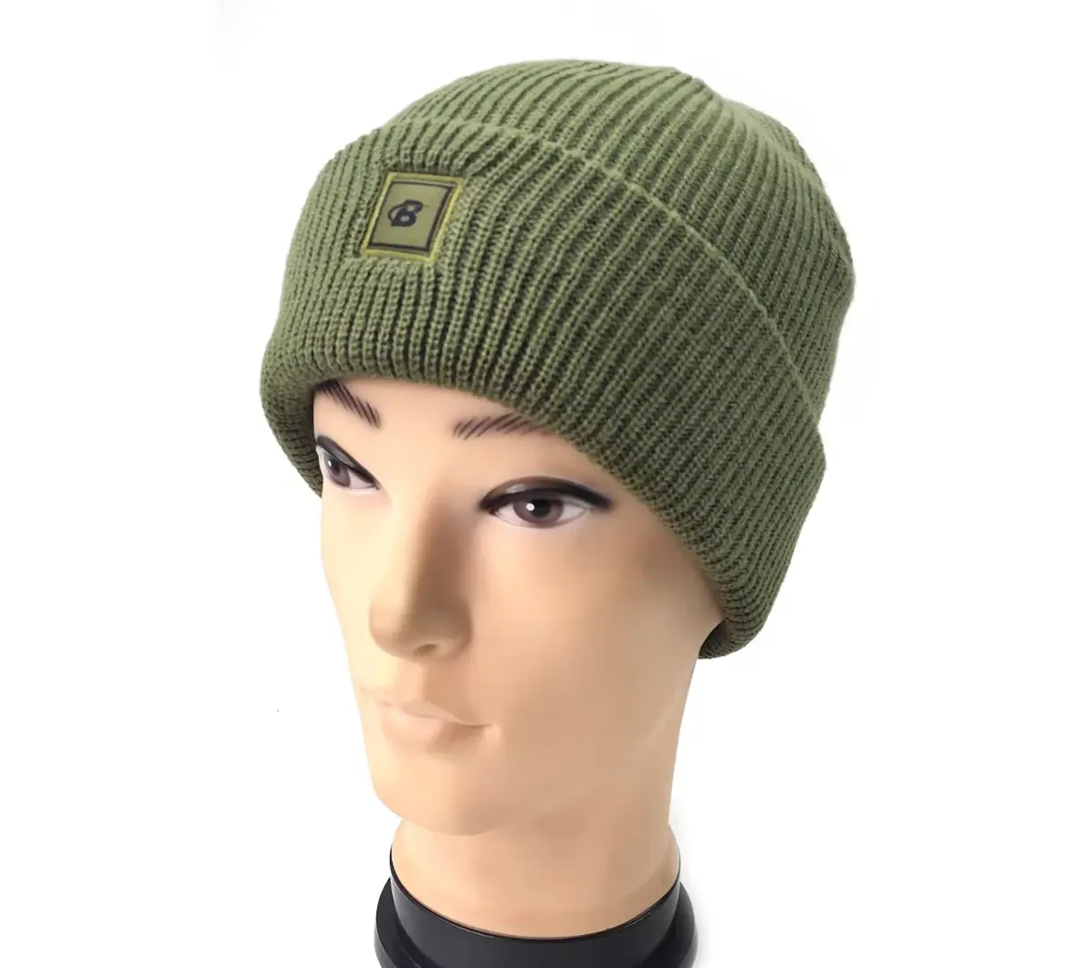 Green rib-knit beanie shown on a mannequin with a small front patch.